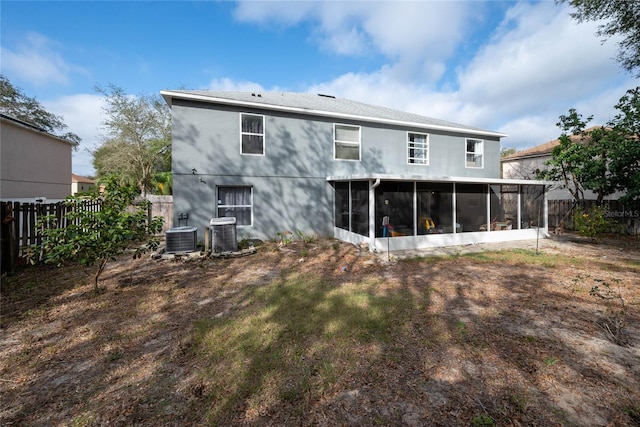 back of house featuring cooling unit, a sunroom, and a fenced backyard