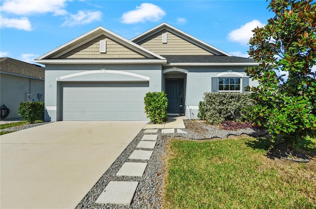 ranch-style home with a garage and a front yard