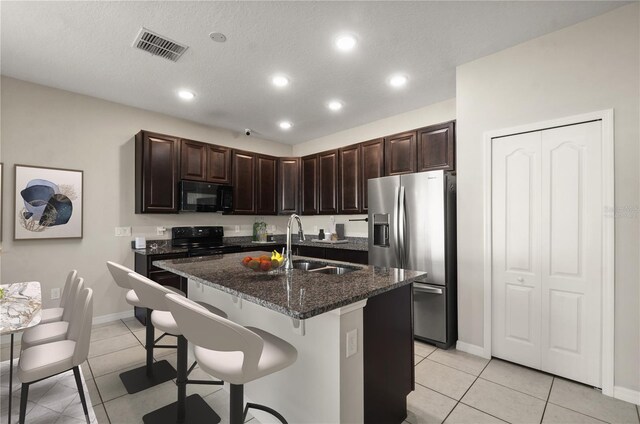 301 E Fiesta Key Loop, Deland, FL 32720 - kitchen with visible vents, a sink, light tile patterned floors, and black appliances