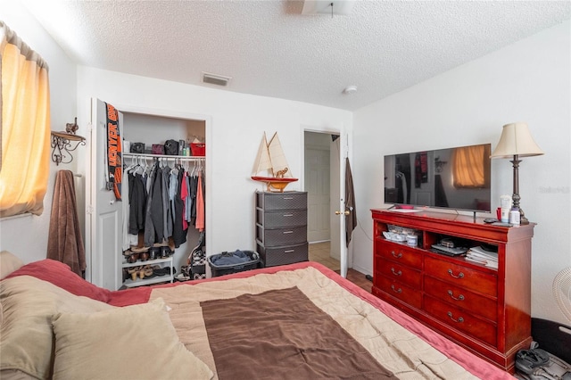 bedroom with a textured ceiling and a closet