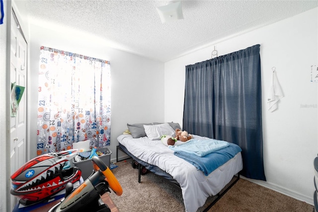 carpeted bedroom featuring a textured ceiling