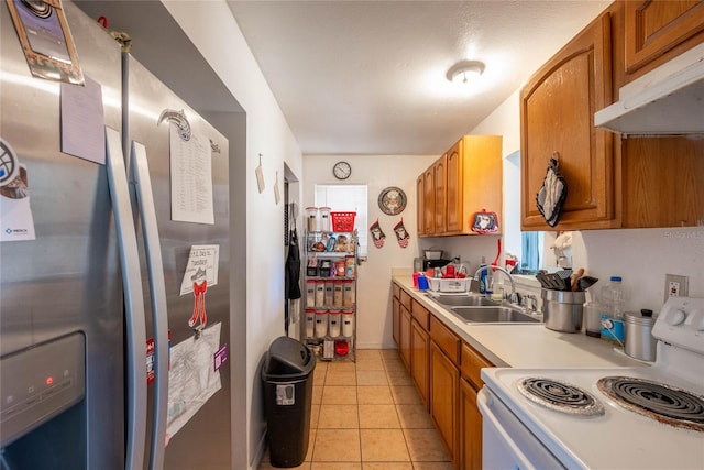 kitchen featuring stainless steel refrigerator with ice dispenser, sink, light tile patterned floors, and electric stove