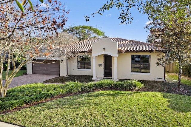 mediterranean / spanish-style home with a garage and a front yard