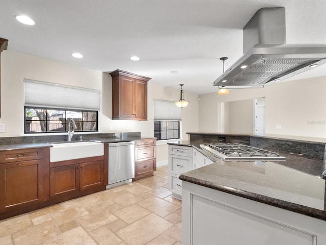 kitchen with island exhaust hood, appliances with stainless steel finishes, decorative light fixtures, and sink