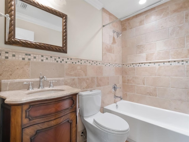 full bathroom with vanity, tiled shower / bath combo, tile walls, and toilet