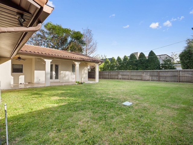 view of yard featuring a patio and ceiling fan