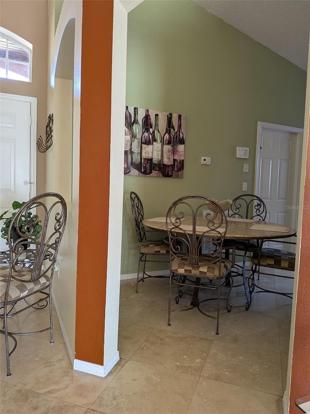 dining space featuring lofted ceiling