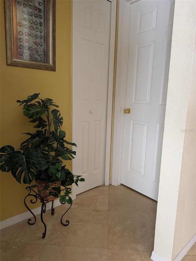 hall with light tile patterned floors