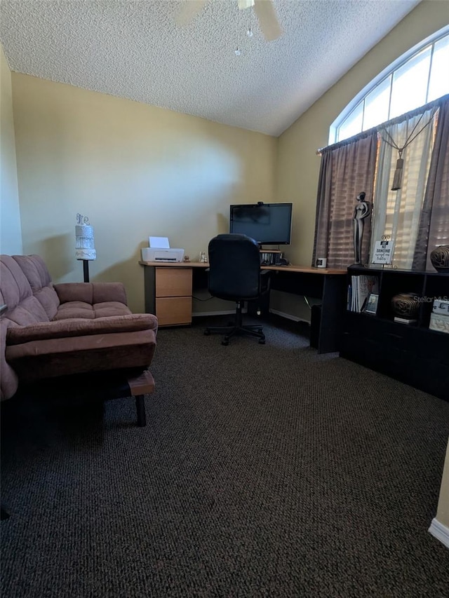 carpeted office space featuring ceiling fan, lofted ceiling, and a textured ceiling