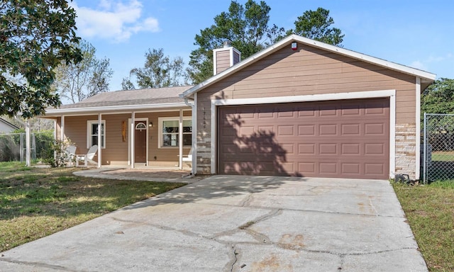 ranch-style house featuring a garage, a front yard, and a porch