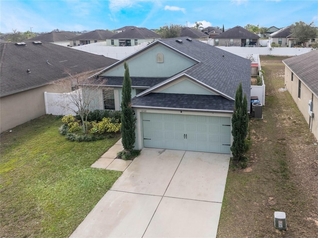 single story home featuring a front yard, central AC, concrete driveway, and roof with shingles