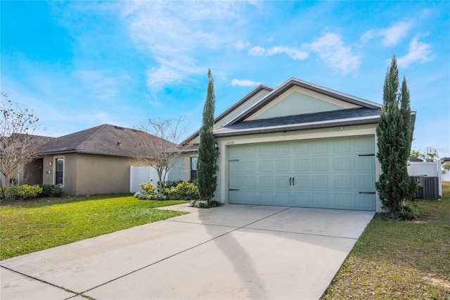 ranch-style home with central air condition unit, stucco siding, concrete driveway, a garage, and a front lawn