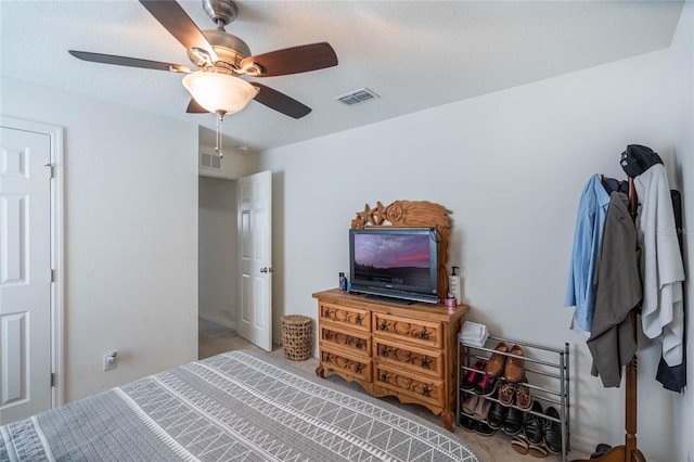 bedroom featuring carpet floors, visible vents, and a ceiling fan