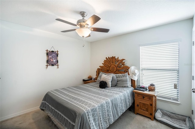 bedroom featuring light carpet, baseboards, and a ceiling fan