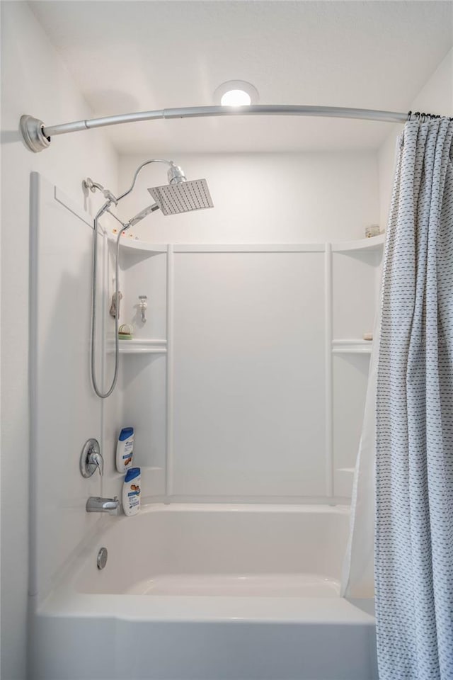 bathroom with shower / bathtub combination with curtain