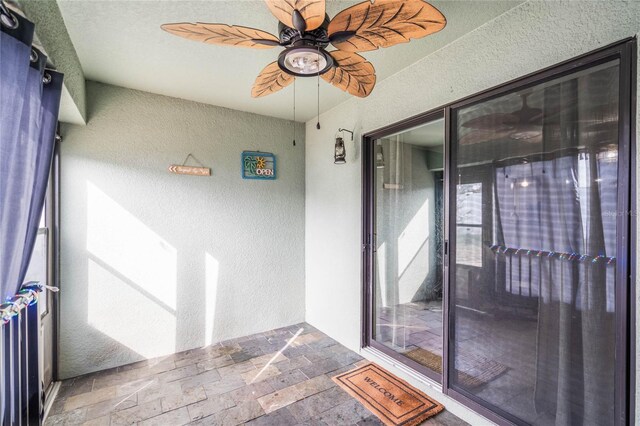 entrance to property with a ceiling fan