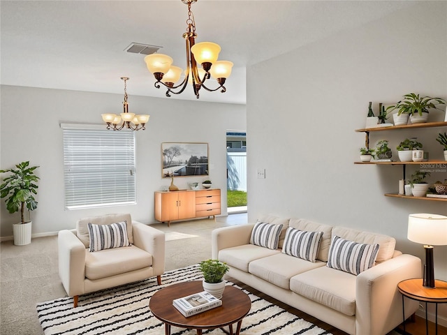 carpeted living room with an inviting chandelier