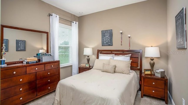 bedroom featuring light carpet