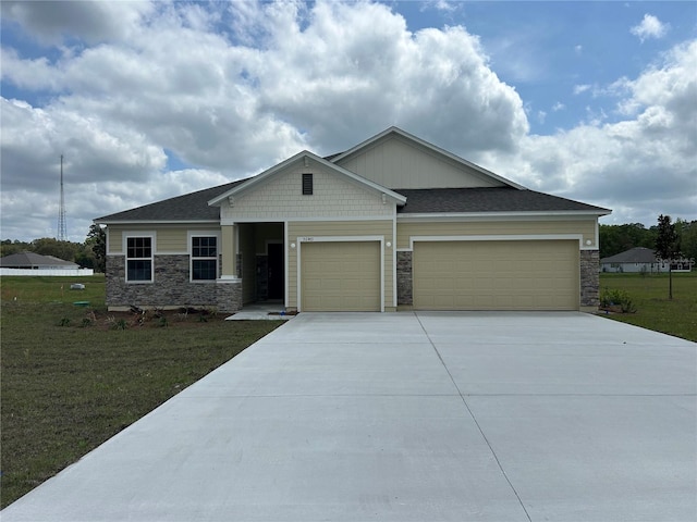 craftsman-style home with a front lawn, stone siding, a garage, and concrete driveway