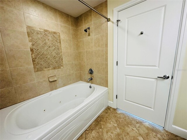 bathroom featuring tile patterned floors and tiled shower / bath