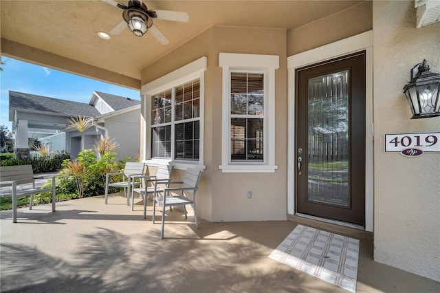 entrance to property featuring ceiling fan and a patio