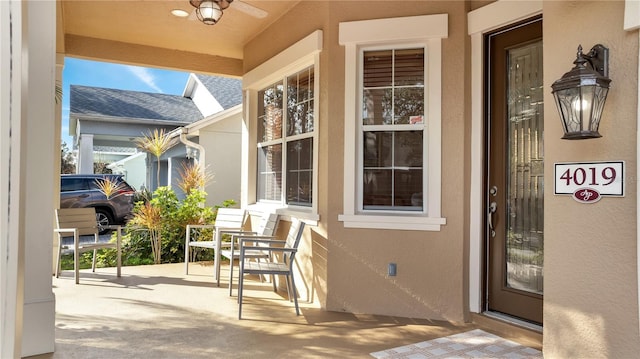 property entrance featuring ceiling fan and a porch