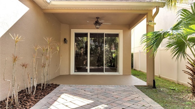 entrance to property featuring a patio and ceiling fan