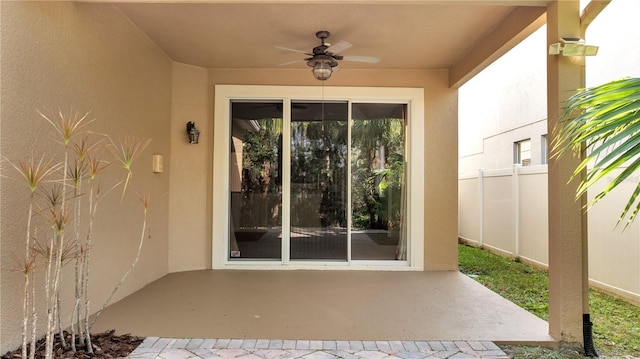 property entrance with a patio area and ceiling fan