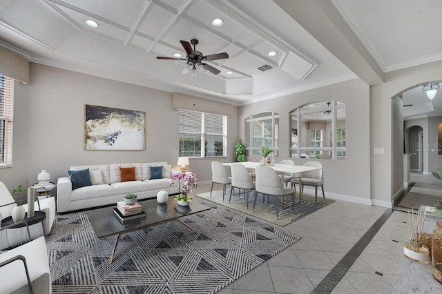 living room with crown molding, ceiling fan, coffered ceiling, and light tile patterned floors