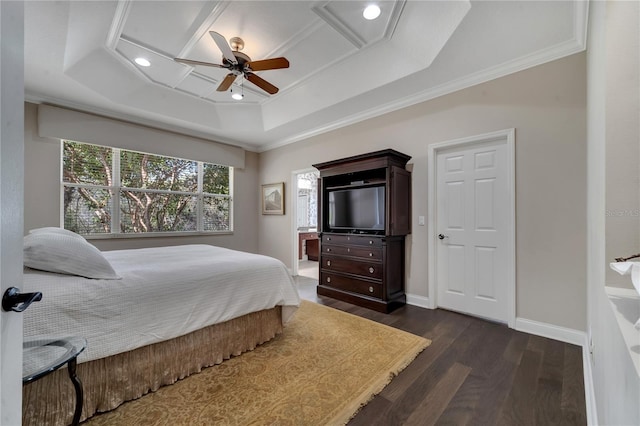 bedroom with dark wood-type flooring, ceiling fan, ornamental molding, and a tray ceiling