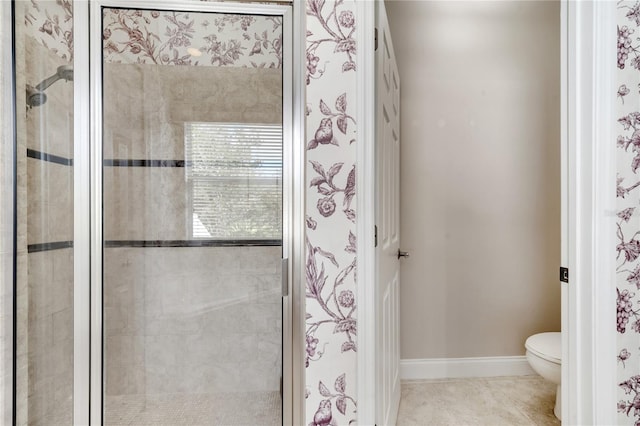 bathroom featuring a shower with door, tile patterned flooring, and toilet