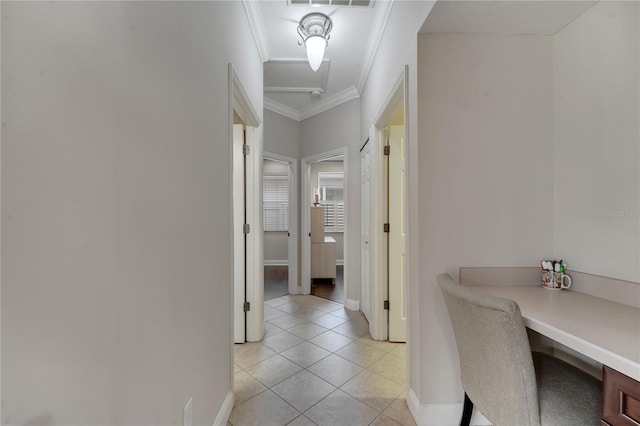 hall featuring crown molding and light tile patterned flooring