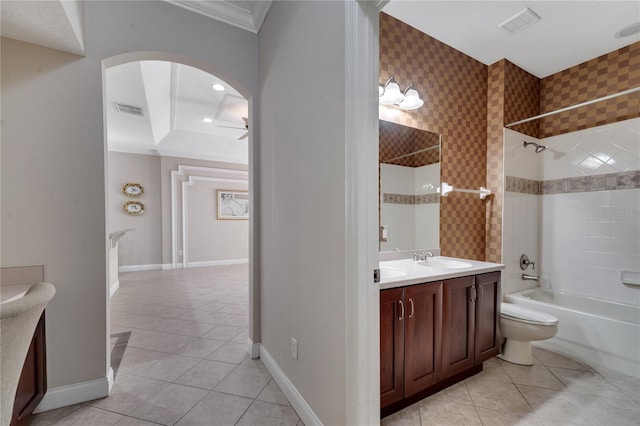 full bathroom with crown molding, tile patterned flooring, tiled shower / bath combo, vanity, and toilet