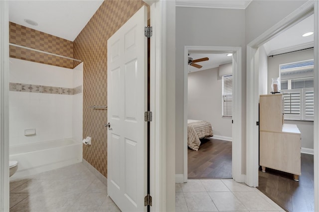 bathroom featuring ceiling fan, shower / bathtub combination, toilet, and tile patterned flooring