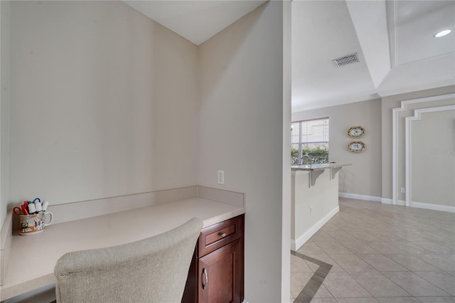 office area with light tile patterned floors and ornamental molding