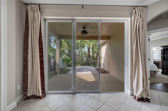 doorway to outside with ceiling fan and light tile patterned floors