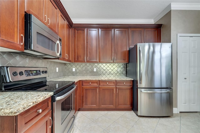 kitchen with stainless steel appliances, crown molding, light stone countertops, and light tile patterned floors