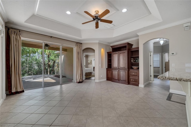 unfurnished living room featuring light tile patterned floors, crown molding, a raised ceiling, and ceiling fan