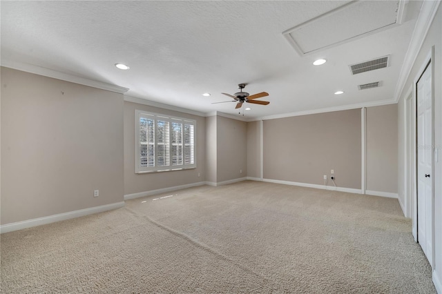 spare room featuring light carpet, crown molding, and ceiling fan