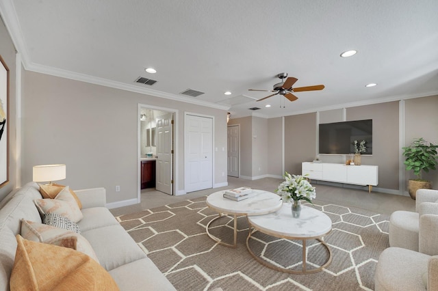 carpeted living room with ornamental molding and ceiling fan