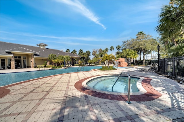 view of pool featuring a patio area and a hot tub