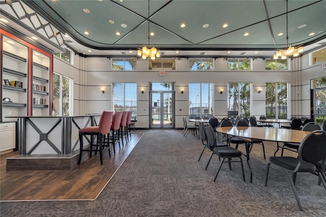 dining room with dark hardwood / wood-style floors and a high ceiling