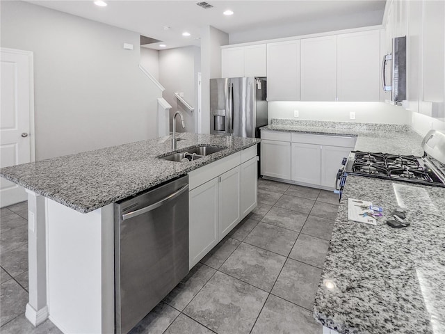 15574 Murcott Blossom Blvd, Winter Garden, FL 34787 - kitchen featuring stainless steel appliances, light stone countertops, a center island with sink, white cabinets, and recessed lighting