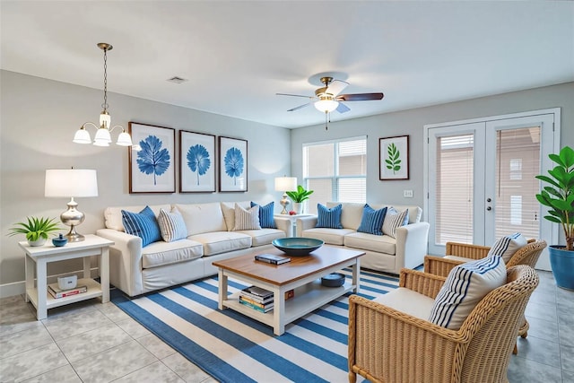15574 Murcott Blossom Blvd, Winter Garden, FL 34787 - living area with light tile patterned floors, a ceiling fan, french doors, and a chandelier
