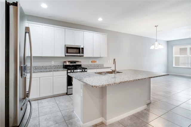 15574 Murcott Blossom Blvd, Winter Garden, FL 34787 - kitchen featuring appliances with stainless steel finishes, light tile patterned flooring, recessed lighting, decorative light fixtures, and white cabinets