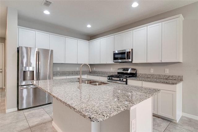 15574 Murcott Blossom Blvd, Winter Garden, FL 34787 - kitchen featuring stainless steel appliances, light tile patterned floors, recessed lighting, white cabinetry, and light stone counters