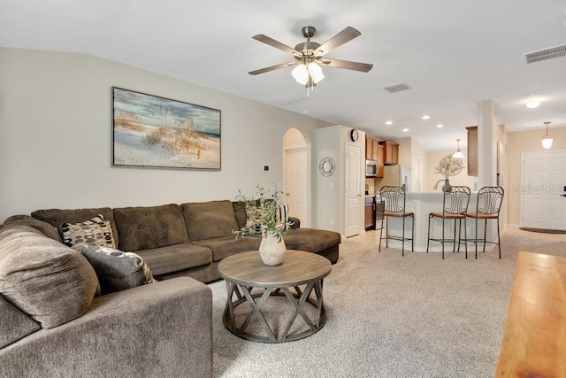 living room featuring light carpet and ceiling fan