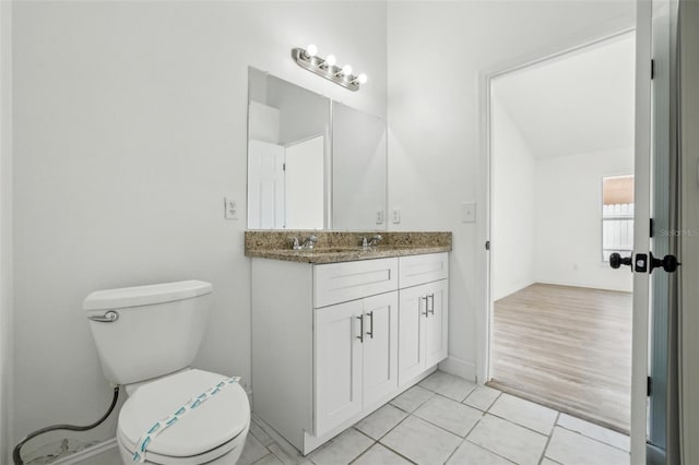 bathroom featuring tile patterned flooring, vanity, and toilet