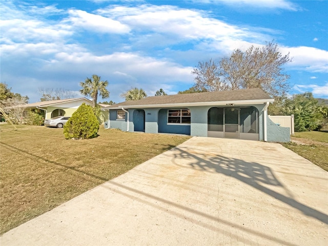 ranch-style home with a sunroom and a front lawn