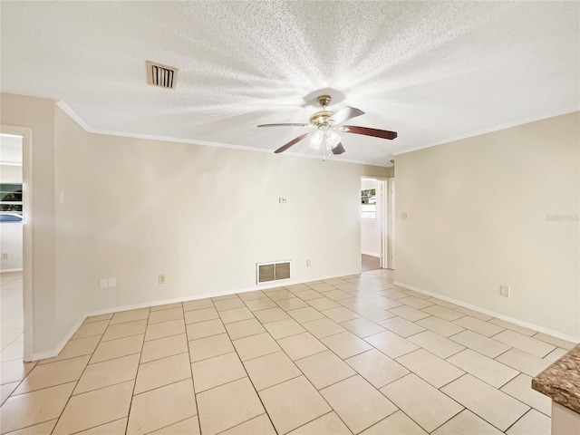 unfurnished room featuring a textured ceiling, ornamental molding, ceiling fan, and light tile patterned flooring